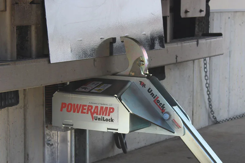 Vehicle restraint system securing trailer at loading dock